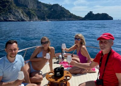 Toast on board off the Amalfi Coast. Two couples enjoying a pleasant day trip on a boat.