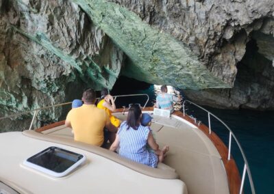 Two families with children exploring Smeralda grotto