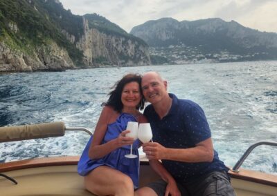 Husband and wife enjoying a romantic and relaxing boat tour of the island of Capri
