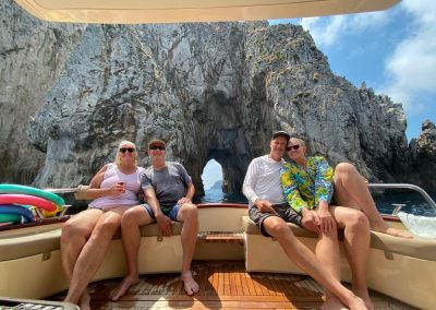 photo below the Faraglioni of Capri, two couples on a rented boat